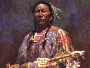 Amérindien en tenue traditionnelle tenant un objet dans ses mains